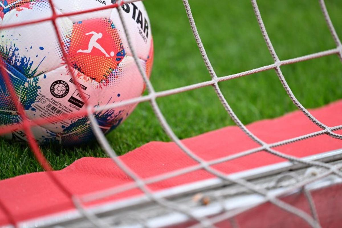 An official Derbystar matchball for the Bundesliga is pictured in the net prior to the German first division Bundesliga football match between 1 FSV Mainz 05 and Borussia Dortmund in Mainz, western Germany on September 27, 2025.  Kirill KUDRYAVTSEV / AFP