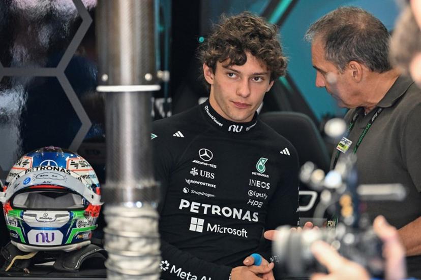 Mercedes' Italian driver Kimi Antonelli (L) speaks with his dad Marco Antonelli (R) before the qualifying session ahead of the Formula One British Grand Prix at the Silverstone motor racing circuit in Silverstone, central England, on July 4, 2026.  PETER POWELL / POOL / AFP