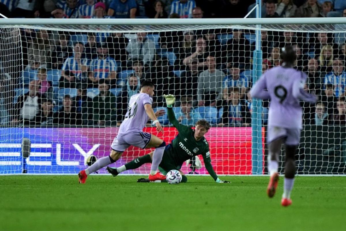 Coventry City's English goalkeeper #19 Carl Rushworth saves a shot from Newcastle United's Belgian striker #20 Matias Fernandez-Pardo during the English Premier League football match between Coventry City and Newcastle United at the Coventry Building Society Arena in Coventry, central England on October 12, 2026.  Ben Stansall / AFP