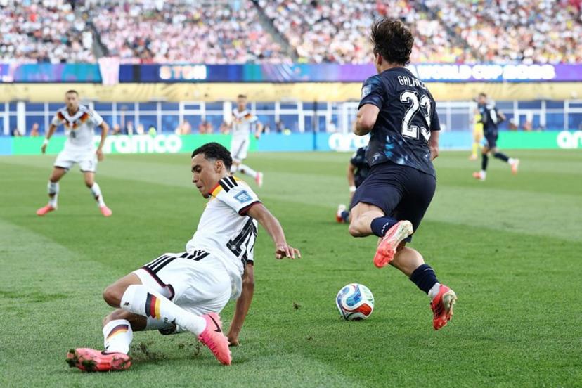 Germany's midfielder #10 Jamal Musiala (L) fouls Paraguay's midfielder #23 Matias Galarza during the 2026 World Cup round of 32 football match between Germany and Paraguay at the Boston Stadium in Foxborough on June 29, 2026.   CHARLY TRIBALLEAU / AFP