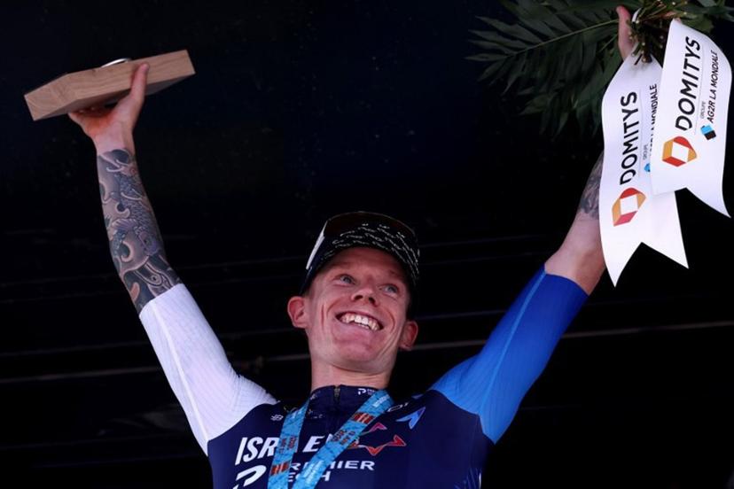 Israel - Premier Tech's British rider Thomas Jake Stewart celebrates winning the stage on the podium of the 5th stage of the 77th edition of the Criterium du Dauphine cycling race, 183 km between Saint-Priest and Mâcon, on June 12, 2025.  Anne-Christine POUJOULAT / AFP