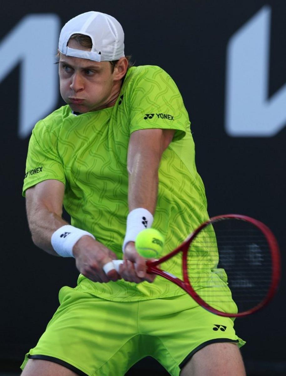 Belgium's Zizou Bergs hits a shot against Poland's Hubert Hurkacz during their men's singles match on day three of the Australian Open tennis tournament in Melbourne on January 20, 2026.  IZHAR KHAN / AFP
