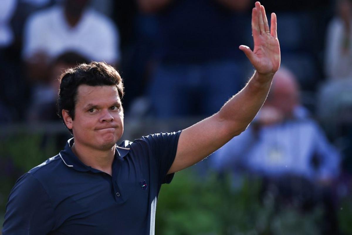 Canada's Milos Raonic celebrates after winning against Britain's Cameron Norrie during the men's singles round of 32 match at the cinch ATP tennis Championships at Queen's Club in west London on June 17, 2024.  HENRY NICHOLLS / AFP