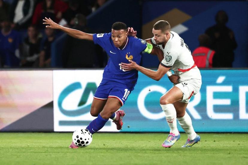 France's forward #10 Kylian Mbappe (L) fights for the ball with Iceland's defender #05 Sverrir Ingason  during the FIFA World Cup 2026 Group D European qualification football match between France and Iceland at the Parc des Princes stadium in Paris, on September 9, 2025.  Thibaud MORITZ / AFP