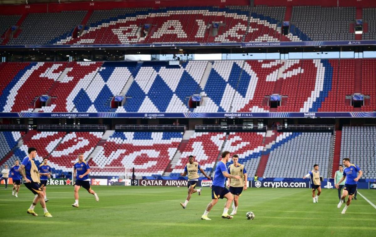 Inter Milan's players attend the MD-1 training session in front of the logo of Bayern Munich on the eve of the UEFA Champions League final football match between Inter Milan and Paris Saint-Germain (PSG) at the Allianz-Arena stadium in Munich, southern Germany, on May 30, 2025.   Marco BERTORELLO / AFP