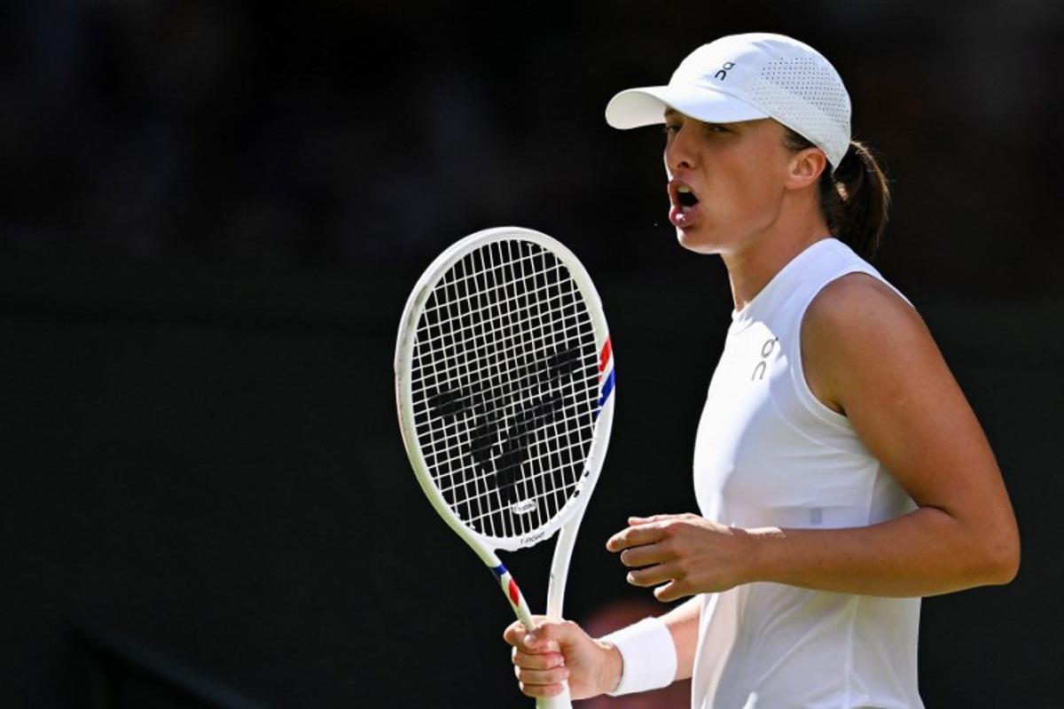 Poland's Iga Swiatek celebrates winning a point against US player Amanda Anisimova during their women's singles final tennis match on the thirteenth day of the 2025 Wimbledon Championships at The All England Lawn Tennis and Croquet Club in Wimbledon, southwest London, on July 12, 2025.  Kirill KUDRYAVTSEV / AFP