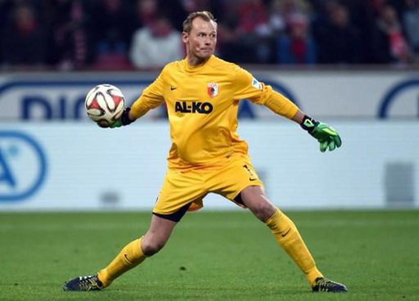 Augsburg's Austrian goalkeeper Alexander Manninger plays the ball during the German first division Bundesliga football match 1 FC Cologne vs FC Augsburg in Cologne, western germany  on December 6, 2014. Augsburg won the match 1-2. AFP PHOTO / PATRIK STOLLARZ  RESTRICTIONS - DFL RULES TO LIMIT THE ONLINE USAGE DURING MATCH TIME TO 15 PICTURES PER MATCH. FOR FURTHER QUERIES PLEASE CONTACT DFL DIRECTLY AT + 49 69 650050