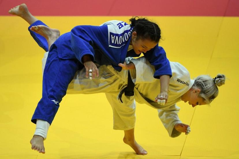 Belgium's Lois Petit competes against Uzbekistan's Khalimajon Kurbonova (blue) in the women's -48kgs qualification round bout of the Judo World Championships in Budapest, Hungary, on June 13, 2025.  Ferenc ISZA / AFP