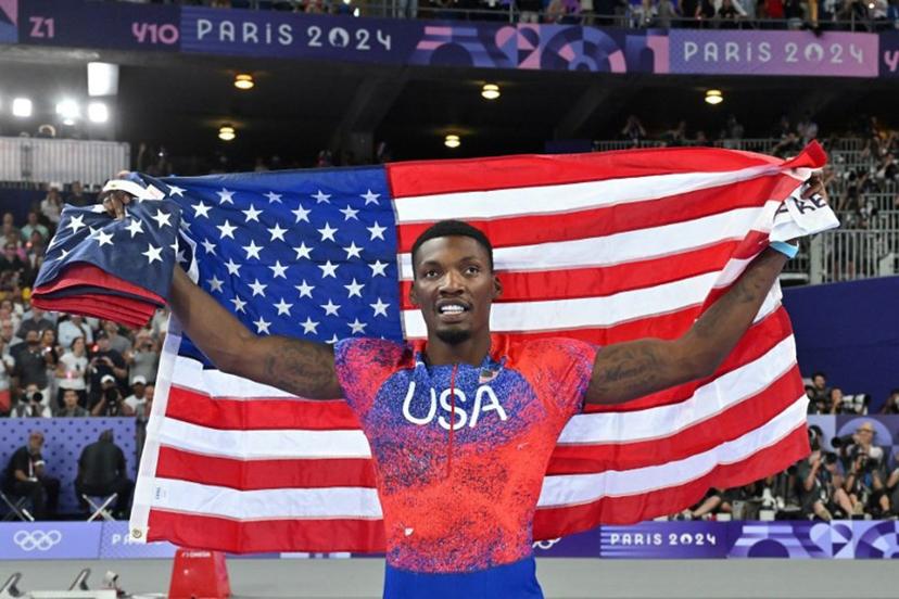 US' Fred Kerley celebrates after winning bronze in the men's 100m final of the athletics event at the Paris 2024 Olympic Games at Stade de France in Saint-Denis, north of Paris, on August 4, 2024.  Andrej ISAKOVIC / AFP
