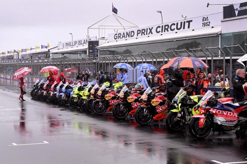 MotoGP bikes are seen lined up after a farewell lap following the cancellation of the last Australian MotoGP Grand Prix to be held at Phillip Island on October 25, 2026, due to inclement weather conditions. Organisers pulled the plug despite a sell-out crowd with persistent rain and poor visibility making racing unsafe. The Moto3 and Moto2 races were also called off. William WEST / AFP