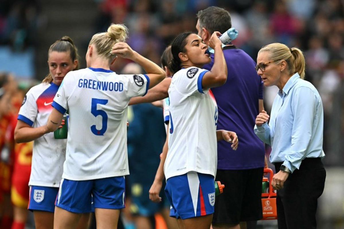 (From L) England's midfielder #10 Ella Toone, England's defender #05 Alex Greenwood and England's defender #16 Jessica Carter listen to England's Dutch coach Sarina Wiegman during the UEFA Women's Euro 2025 final football match between England and Spain at the St. Jakob-Park Stadium in Basel, on July 27, 2025.  Fabrice COFFRINI / AFP