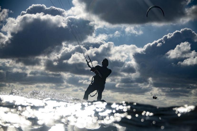 A kitesurfer catches air of the coast in Lège-Cap Ferret, southwestern France on June 8 2020.     Olivier MORIN / AFP