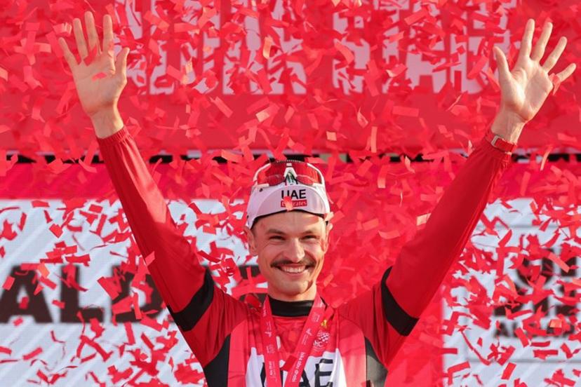 UAE Team Emirates' Australian cyclist Jay Vine celebrates being the leader of the race on the podium following stage 6 of the 6th UAE Cycling Tour from the Louvre Abu Dhabi to Abu Dhabi Breakwater on February 24, 2024.  Giuseppe CACACE / AFP