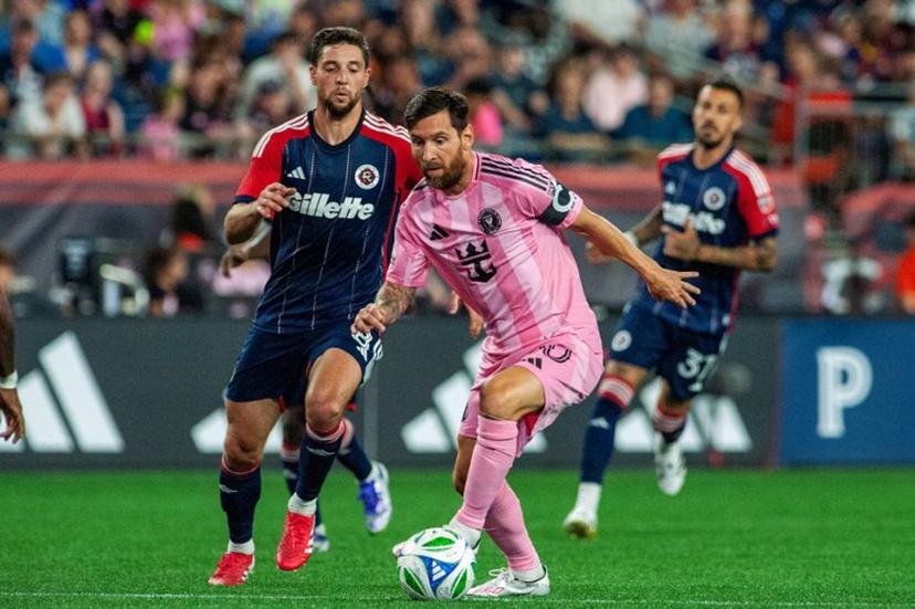 Inter Miami's Argentine forward #10 Lionel Messi runs with the ball next to New England's US midfielder #08 Matt Polster during the Major League Soccer (MLS) regular season match between New England Revolution and Inter Miami CF at Gillette Stadium in Foxborough, Massachusetts on July 9, 2025.  Joseph Prezioso / AFP