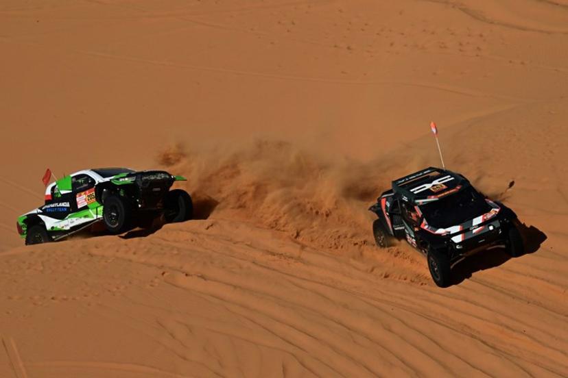 The Dacia Sandriders's (L) Qatari driver Nasser Al‑Attiyah and Belgian co‑pilot Fabian Lurquin and Polish driver Energylandia Rally Team's Eryk Goczal and Polish co‑pilot Szymon Gospodarczyk compete in the Stage 6 of the 48th edition of the Dakar Rally 2026, between Hail and Riyadh, Saudi Arabia, on January 9, 2026.  Giuseppe CACACE / AFP