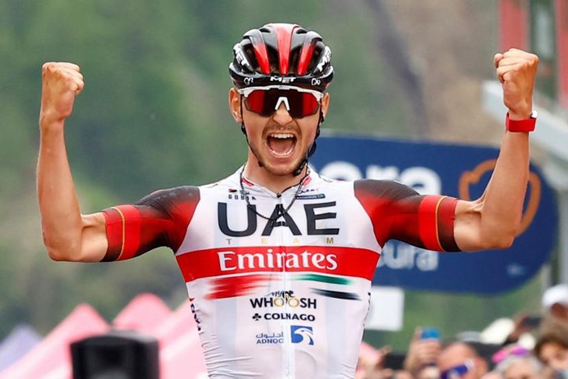 Team UAE Emirates' Italian rider Alessandro Covi celebrates as he crosses the finish line to win the 20th stage of the Giro d'Italia 2022 cycling race, 168 kilometers from Belluno to Marmolada (Passo Fedaia) on May 28, 2022.  Roberto Bettini / AFP