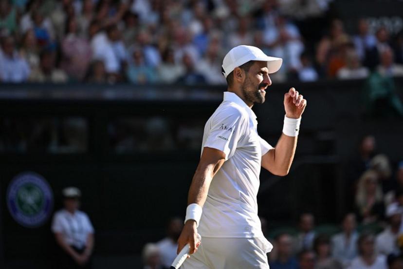 Serbia's Novak Djokovic reacts as he plays against Italy's Flavio Cobolli during their men's singles quarter-final tennis match on the tenth day of the 2025 Wimbledon Championships at The All England Lawn Tennis and Croquet Club in Wimbledon, southwest London, on July 9, 2025.  Kirill KUDRYAVTSEV / AFP