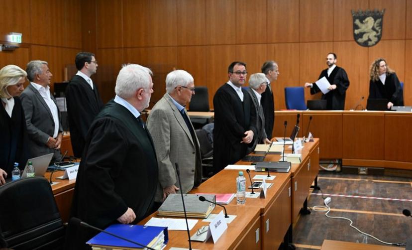 Former Presidents of Germany's Football Federation (Deutscher Fussball Bund, DFB) Theo Zwanziger (1st row, 2nd L) and Wolfgang Niersbach (2nd row, 2nd L) are seen next to their lawyers as they wait for the continuation of a trial for tax fraud amounting to 13.7 million euros for the benefit of the DFB in connection with the 2006 World Cup hosted by Germany, in Frankfurt am Main, western Germany, April 15, 2024.  Arne Dedert / POOL / AFP