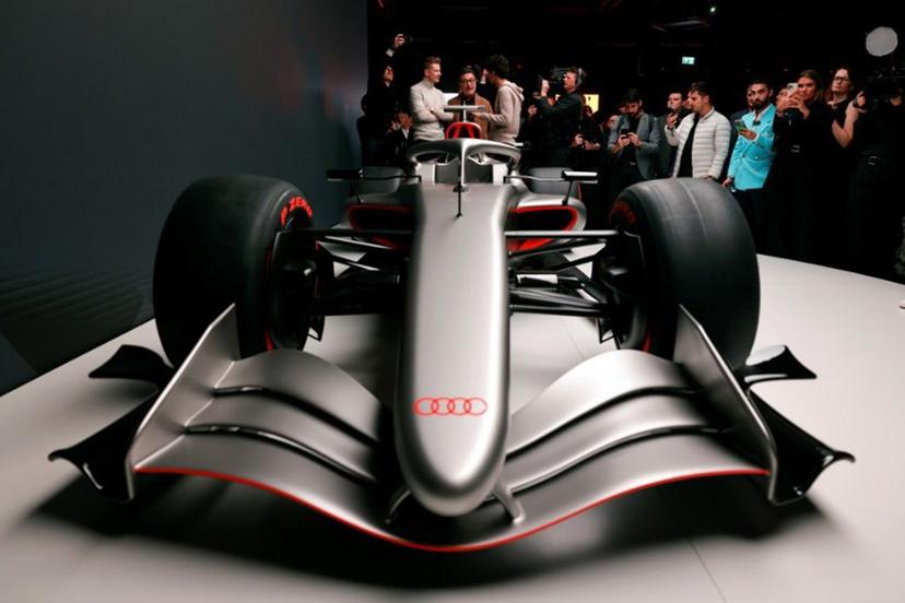 Massimo Frascella (C), Chief Creative Officer at AUDI AG, together with Kick Sauber's German driver Nico Hulkenberg (L) and Kick Sauber's Brazilian driver Gabriel Bortoleto (R) unveils the F1 car of the Audi F1 factory team set to compete in the Formula One starting in the 2026 season in Munich, southern Germany on November 12, 2025.  Alexandra BEIER / AFP