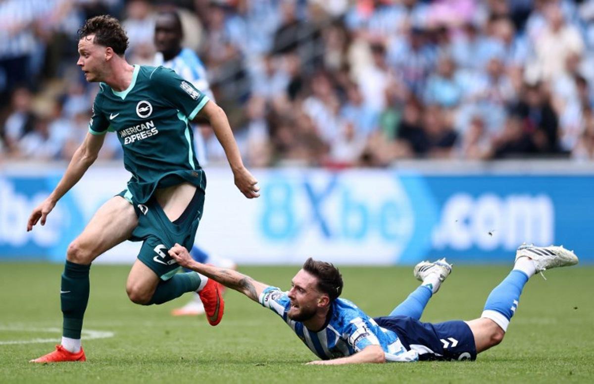 Coventry City's English midfielder #06 Matt Grimes (R) pulls on Brighton's Belgian defender #29 Maxim De Cuyper (L) as they vie for the ball during the English Premier League football match between Coventry City and Brighton and Hove Albion at the Coventry Building Society Arena in Coventry, central England on September 13, 2026.  Henry NICHOLLS / AFP
