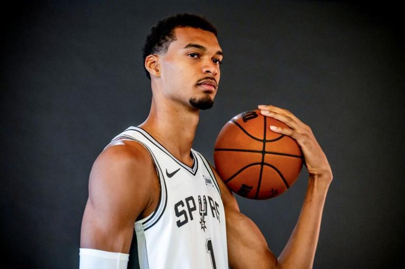 French basketball player Victor Wembanyama poses for promotional photos during the San Antonio Spurs media day at the Victory Capital Performance Center in San Antonio, Texas on September 29, 2025. After making a thunderous return to the court on Wednesday with a 40-point performance, French phenomenon Victor Wembanyama has not escaped the eternal debate about height in the NBA -- where measurements are often surrounded by a certain amount of mystery. A clerical error before the start of the season reignited the rumor mill around the San Antonio Spurs star, who says he is "surprised that it's still a conversation". SERGIO FLORES / AFP
