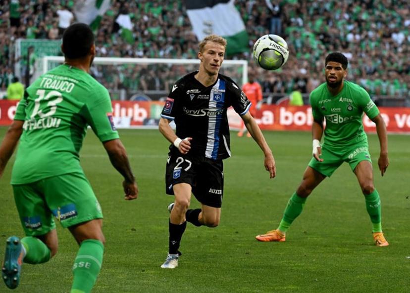 Auxerre's French midfielder Alexis Trouillet (C) fights for the ball with Saint-Etienne's Peruvian defender Miguel Trauco (L) and Saint-Etienne's French midfielder Mahdi Camara  during the French L1-L2 play-off football match between AS Saint-Etienne and AJ Auxerre at the Geoffroy Guichard Stadium in Saint-Etienne, central-eastern France on May 29, 2022.  JEAN-PHILIPPE KSIAZEK / AFP