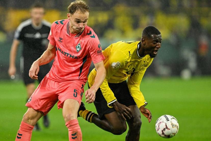 Bremen's German defender #05 Amos Pieper (L) and Dortmund's Guinean forward #09 Serhou Guirassy vie for the ball during the German Cup (DFB-Pokal) football match between BVB Borussia Dortmund and Werder Bremen in Dortmund, western Germany on October 27, 2026.  INA FASSBENDER / AFP