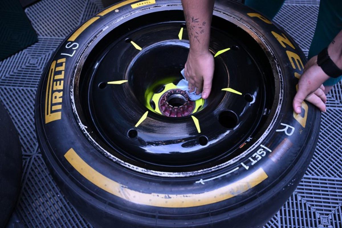 Aston Martin's technician prepares a tyre at the Spa-Francorchamps circuit in Spa on July 25, 2024, ahead of the Formula One Belgian Grand Prix. The Formula One Belgian Grand Prix at the Spa-Francorchamps circuit will be held on July 28, 2024. JOHN THYS / AFP
