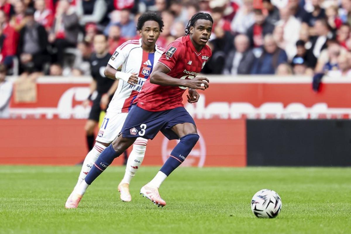 Lille's Belgian defender #03 Nathan Ngoy runs with the ball during the French L1 football match between Lille LOSC and Olympique Lyonnais (OL) at the Stade Pierre-Mauroy in Villeneuve-d'Ascq, northern France, on September 28, 2025.  Sameer Al-DOUMY / AFP