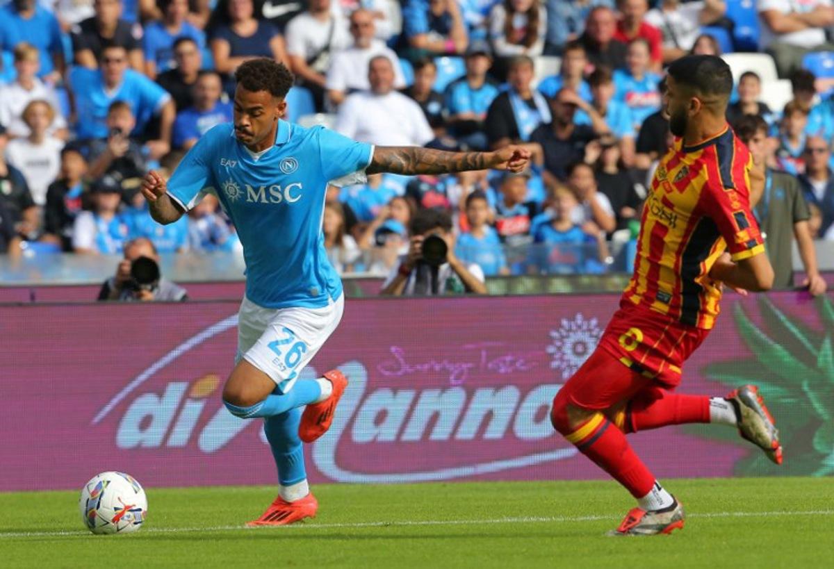 Napoli's Belgian forward #26 Cyril Ngonge fights for the ball with Lecce's Montenegrin forward #09 Nikola Krstovic during the Italian Serie A football match between Napoli and Lecce at the Diego Armando Maradona stadium in Naples on October 26, 2024.  CARLO HERMANN / AFP