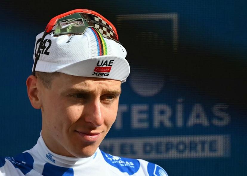 Team UAE's Slovenian rider Tadej Pogacar wearing the best climber's dotted jersey celebrates on the podium of the sixth stage of the Vuelta a Espana 2026, a 177,4 km race between Alcossebre and Castellon de la Plana on August 27, 2026.    JOSE JORDAN / AFP
