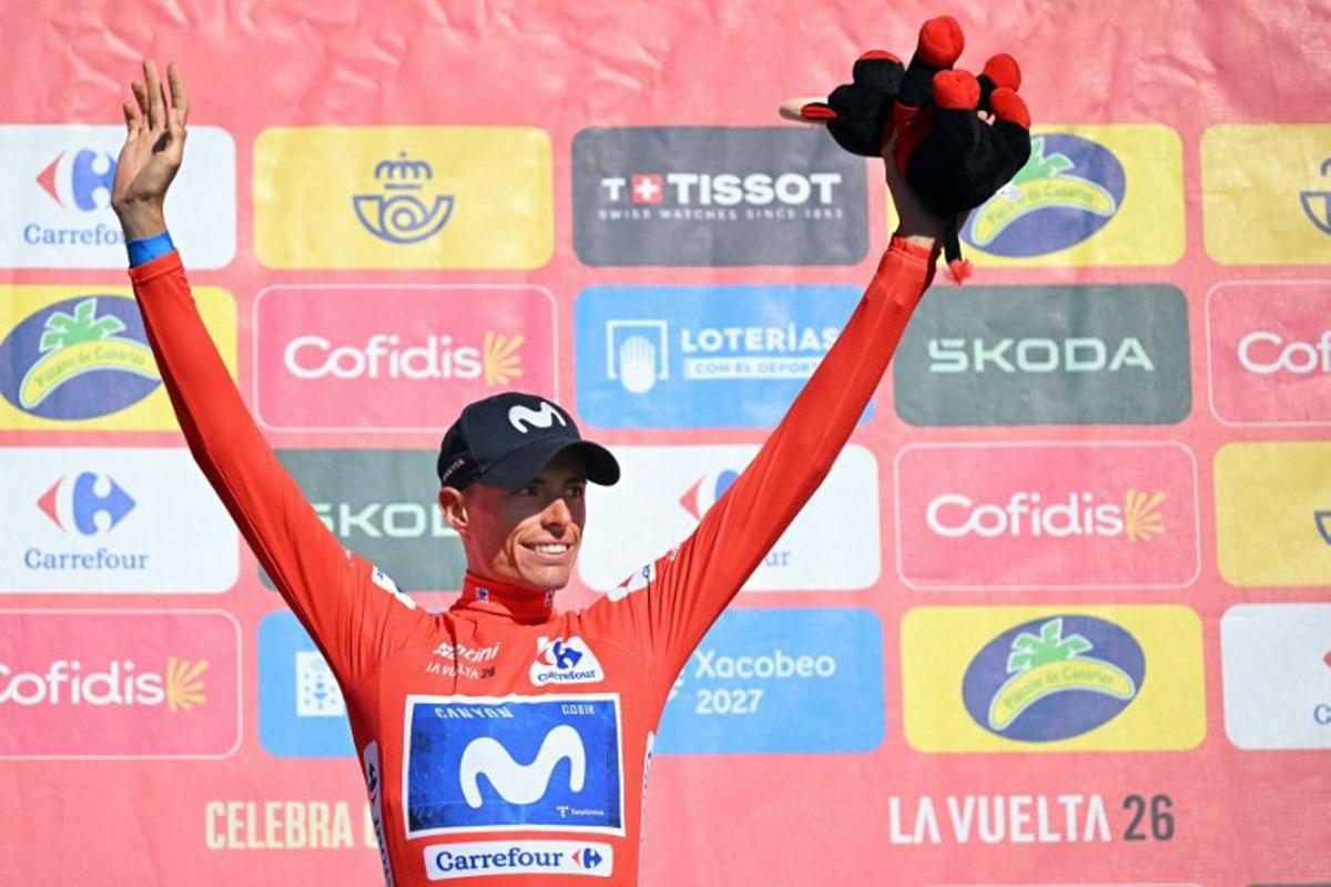 Overall leader Team Movistar's Spanish rider Enric Mas celebrates on the podium retaining the red jersey after the 20th stage of the Vuelta a Espana 2026 cycling tour, a 186,8 km race between La Calahorra and Collado del Alguacil, on September 12, 2026.  Home favourite Enric Mas moved to the brink of Vuelta a Espana victory today as he finished the 20th and penultimate stage by extending his lead on Primoz Roglic in the overall standings. JORGE GUERRERO / AFP