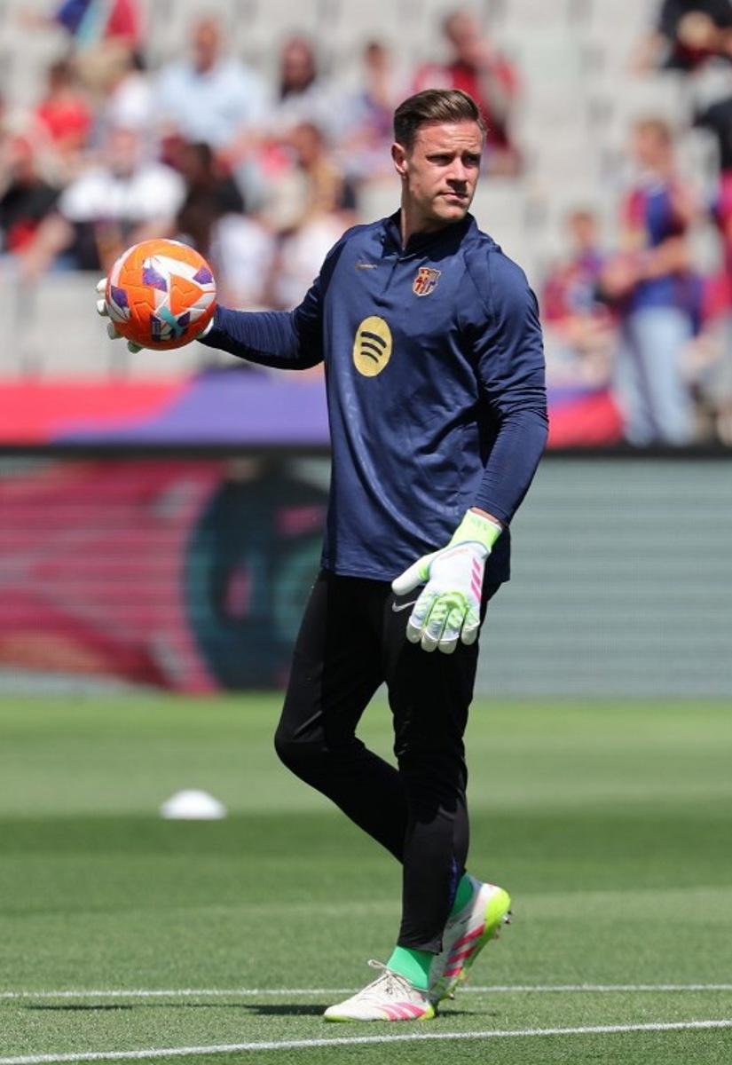 Barcelona's German goalkeeper #01 Marc-Andre Ter Stegen warms up before the Spanish league football match between FC Barcelona and Real Madrid CF at Estadi Olimpic Lluis Companys in Barcelona, on May 11, 2025.  LLUIS GENE / AFP