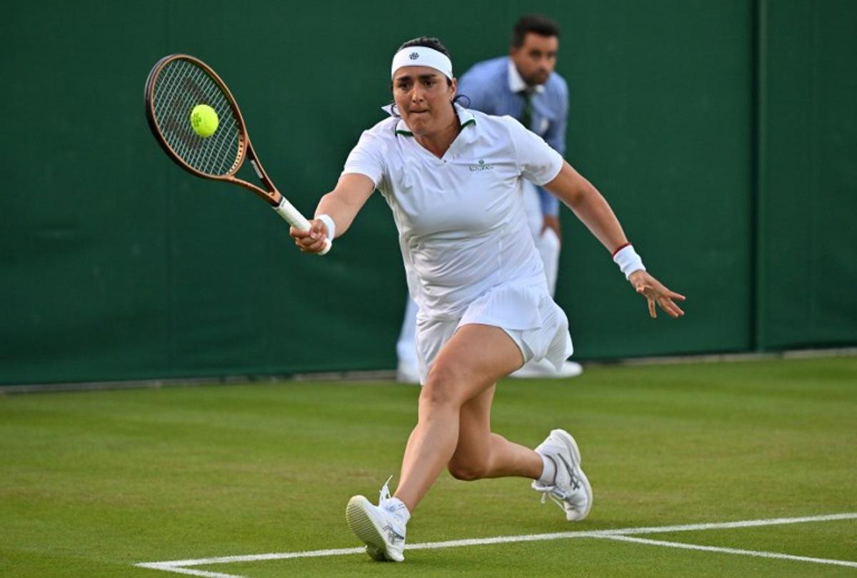 Tunisia's Ons Jabeur returns against Japan's Moyuka Uchijima during their women's singles tennis match on the second day of the 2024 Wimbledon Championships at The All England Lawn Tennis and Croquet Club in Wimbledon, southwest London, on July 2, 2024. Jabeur won the match 6-3, 6-1. Glyn KIRK / AFP