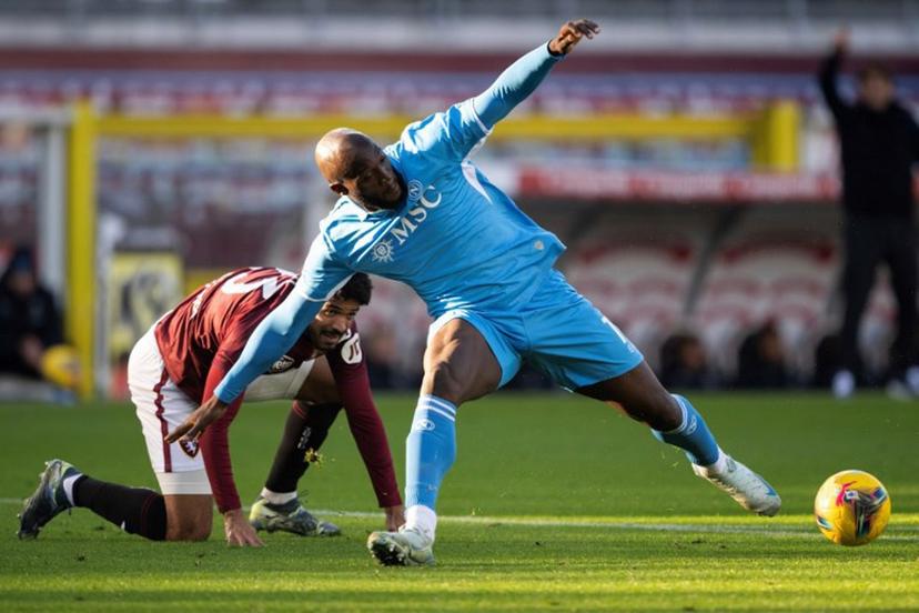 Napoli's Belgian forward #11 Romelu Lukaku (R) stretches to control the ball ahead of Torino's Equatorial Guinea defender #23 Saul Basilio Coco-Bassey Oubina (L) during the Italian Serie A football match between Torino FC and SSC Napoli at the Olympic Grande Torino Stadium in Turin on December 1, 2024.  MARCO BERTORELLO / AFP