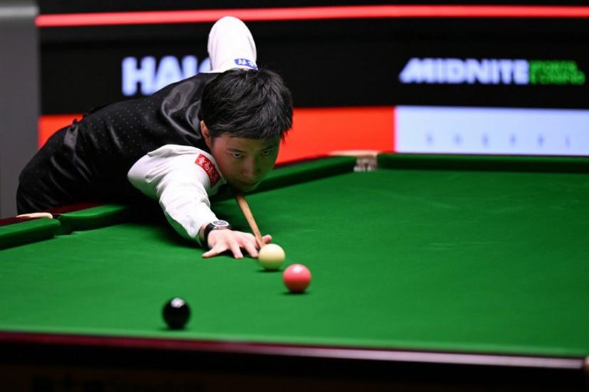 China's Zhao Xintong plays a shot on day two of his World Championship Snooker final against Wales' Mark Williams during the afternoon session at The Crucible in Sheffield, northern England on May 5, 2025.   Oli SCARFF / AFP