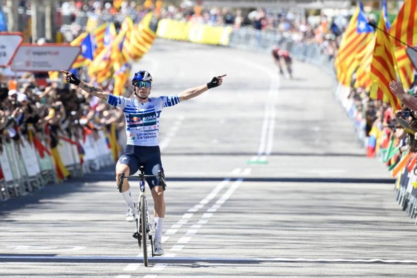 Team Bora's Primoz Roglic celebrates as he crosses the finish line to win the 7th and final stage of the 2025 Volta a Catalunya cycling tour of Catalonia race, a 88,2 km loop between Barcelona and Barcelona, on March 30, 2025. Roglic won the Vuelta a Catalunya on Sunday, soloing through the seventh and final stage in Barcelona, where his main rival Juan Ayuso (UAE) fell behind in the final. Roglic, who was a second behind Ayuso at the start of this final stage, broke away with 20 km to go and managed to maintain his lead to secure his second Volta a Catalunya victory. Josep LAGO / AFP