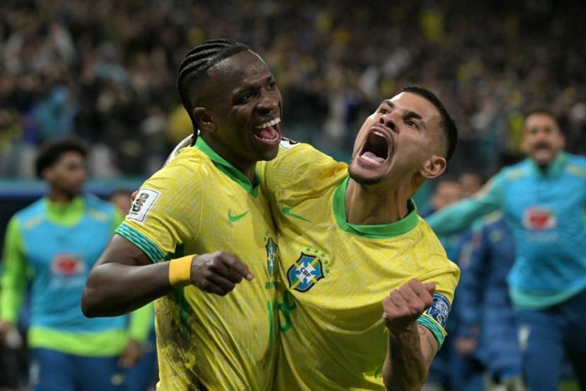 Brazil's forward #10 Vinicius Jr celebrates with teammate midfielder #08 Bruno Guimaraes after scoring his team's first goal during the 2026 FIFA World Cup South American qualifiers football match between Brazil and Paraguay at the Neo Quimica Arena in Sao Paulo, Brazil, on June 10, 2025.   NELSON ALMEIDA / AFP