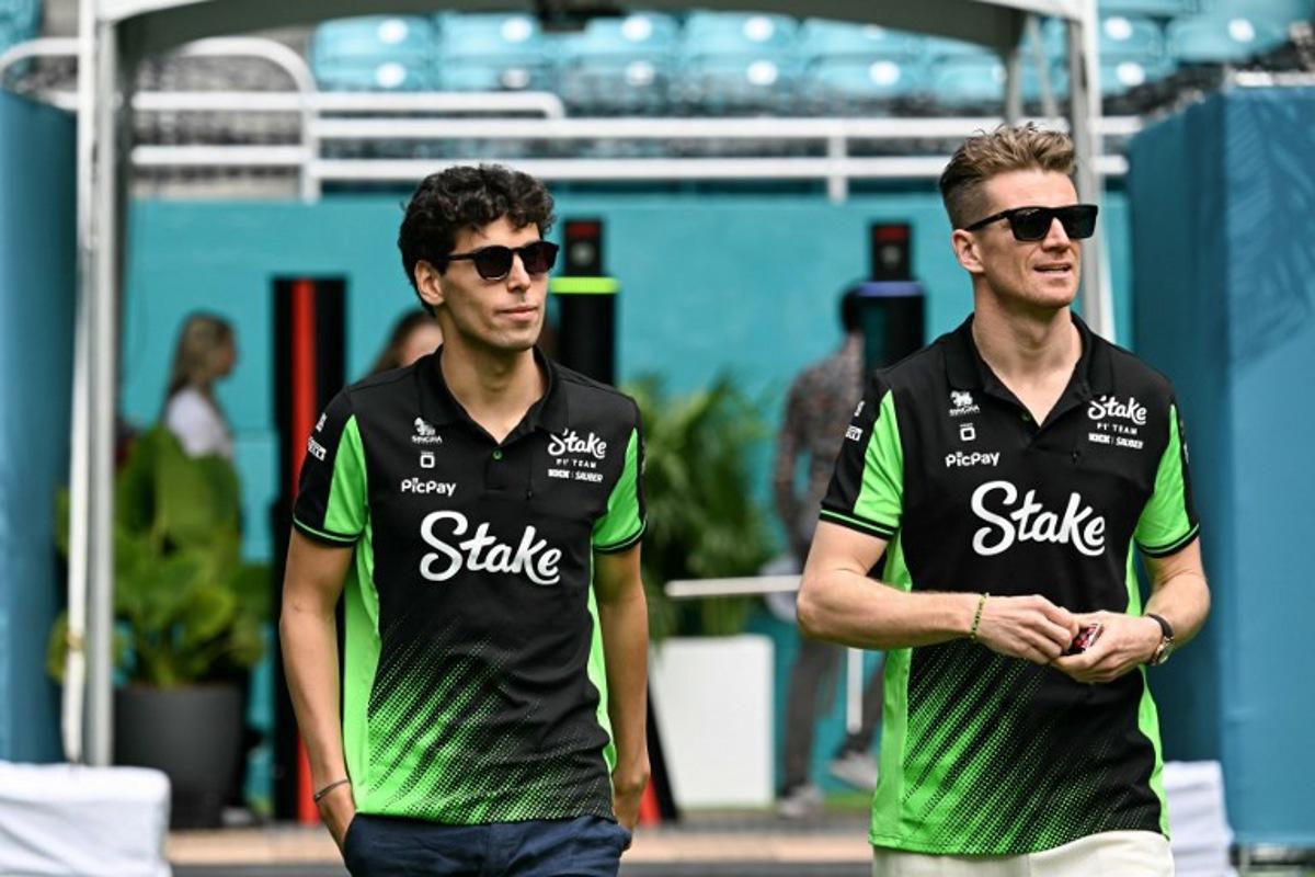 (L-R) Kick Sauber's Brazilian reserve driver Gabriel Bortoleto and Kick Sauber's German driver Nico Hulkenberg arrive ahead of practice session for the 2025 Miami Formula One Grand Prix at Miami International Autodrome in Miami Gardens, Florida, on May 2, 2025.   Chandan Khanna / AFP