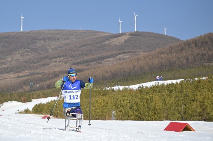 Ukraine's Pavlo Bal competes in the men's middle distance sitting para cross-country skiing final event on March 12, 2022, at the Zhangjiakou National Biathlon Centre during the Beijing 2022 Winter Paralympic Games.  Mohd RASFAN / AFP