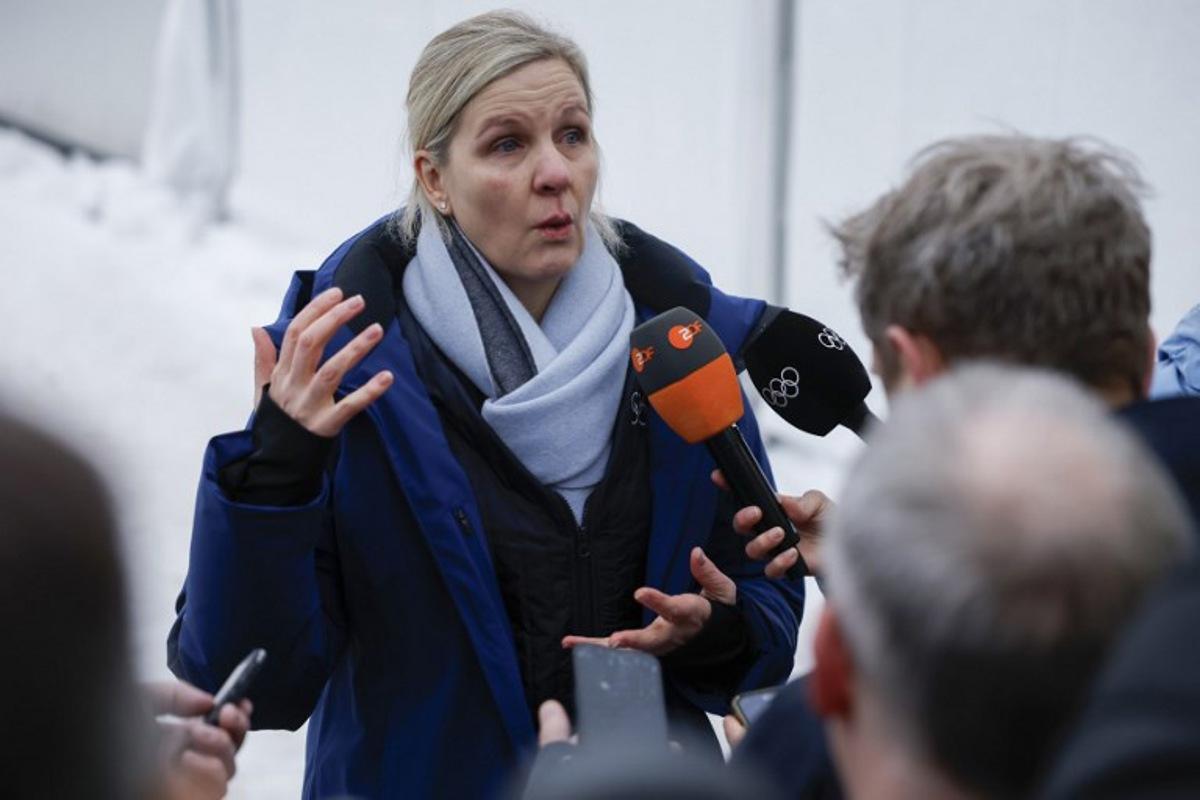 President of the International Olympic Committee (IOC) Kirsty Coventry speaks to the press after Ukraine's Vladyslav Heraskevych was disqualified from the Milano Cortina 2026 Winter Olympic Games in Cortina d'Ampezzo on February 12, 2026. Ukrainian skeleton racer Vladyslav Heraskevych was disqualified from the Winter Olympics on February 12, 2026 after refusing to back down over his banned helmet, which depicts victims of his country's war with Russia. In a statement, the International Olympic Committee said Heraskevych is "not allowed to participate at Milano-Cortina 2026 after refusing to adhere to the IOC athlete expression guidelines".  Odd ANDERSEN / AFP