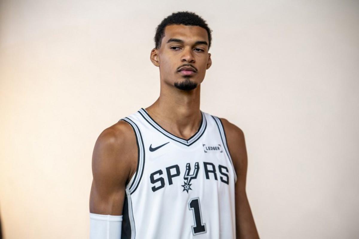 French basketball player Victor Wembanyama poses for promotional photos during the San Antonio Spurs media day at the Victory Capital Performance Center in San Antonio, Texas on September 29, 2025. Wembanyama has been cleared by the team's medical staff to play for the upcoming season. SERGIO FLORES / AFP