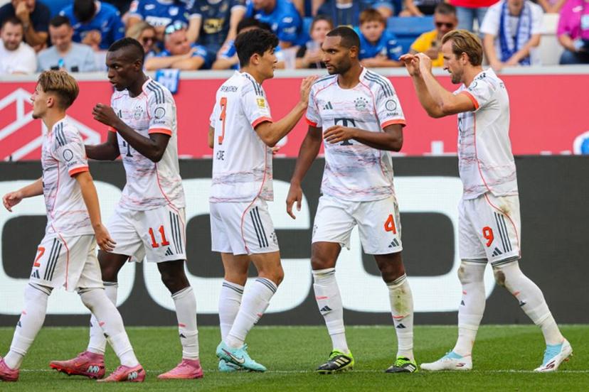 Bayern Munich's English forward #09 Harry Kane (R) celebrates with team mates after scoring the 0-2 from a penalty shot during the German first division Bundesliga football match between TSG 1899 Hoffenheim and FC Bayern Munich in Sinsheim, southwestern Germany on September 20, 2025.  Daniel ROLAND / AFP