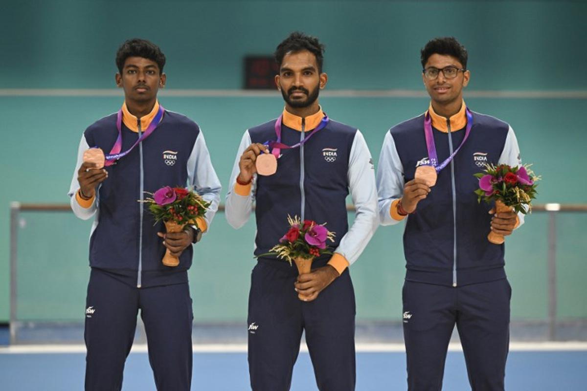 Bronze medallists India's Vikram Rajendra Ingale, Anandkumar Velkumar and Siddhant Rahul Kamble attend the awards ceremony of the men's 3000m relay speed skating event during the 2022 Asian Games in Hangzhou in China's eastern Zhejiang province on Octorber 2, 2023.  WANG Zhao / AFP