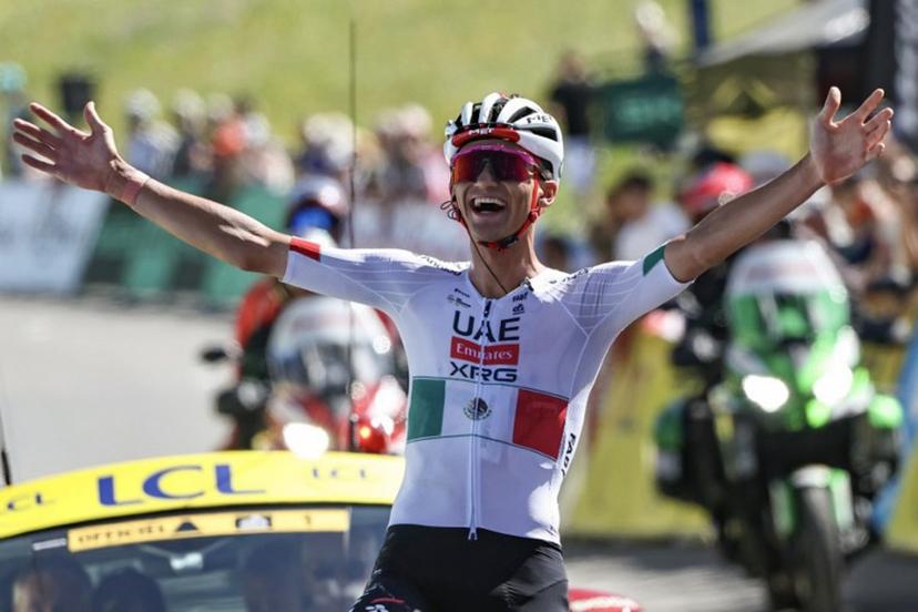 UAE Team Emirates XRG's Mexican rider Isaac Del Toro Romero celebrates as he cycles to the finish line to win the 8th and final stage of the Tour Auvergne-Rhone-Alpes cycling race (formerly known as the Criterium du Dauphine), 120,1km between Beaufort and Plateau de Solaison, in the French Alps on June 14, 2026.  Anne-Christine POUJOULAT / AFP