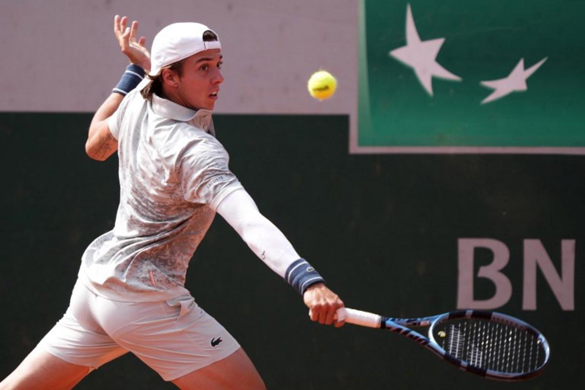 France's Arthur Cazaux plays a backhand return to Chile's Alejandro Tabilo during their men's singles match on day 2 of the French Open tennis tournament at the Roland-Garros Complex in Paris on May 26, 2025.  Dimitar DILKOFF / AFP