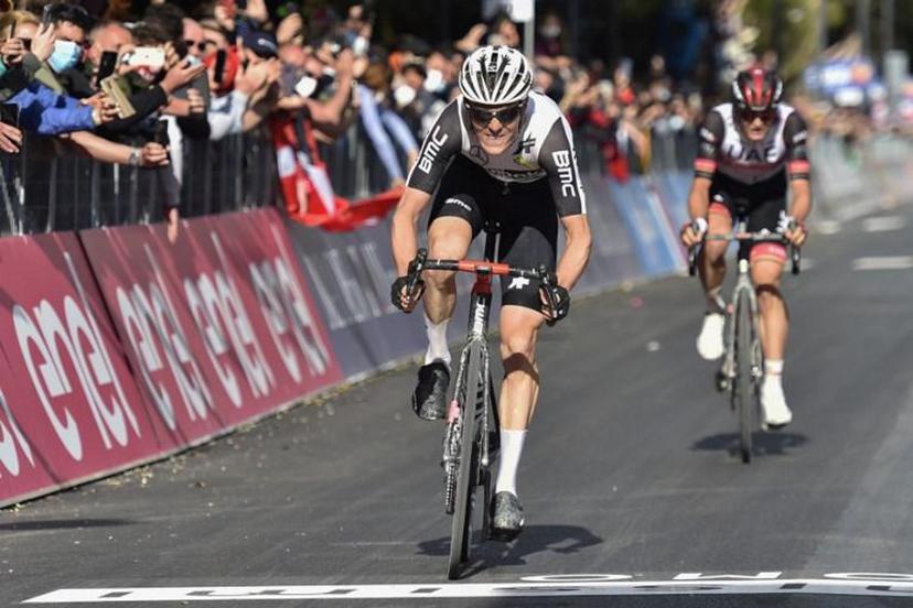 Team Qhubeka Assos rider Switzerland's Mauro Schmid (C) followed by Team UAE Emirates rider Italy's Alessandro Covi, rides to cross the finish line to win the eleventh stage of the Giro d'Italia 2021 cycling race, 162 km between Perugia and Montalcino on May 19, 2021.   Tommaso Pelagalli / AFP