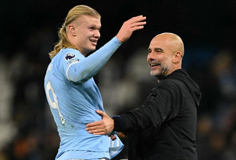 Manchester City's Norwegian striker #09 Erling Haaland (L) reacts with Manchester City's Spanish manager Pep Guardiola after the English Premier League football match between Manchester City and Leeds United at the Etihad Stadium in Manchester, north west England, on November 29, 2025.  Oli SCARFF / AFP