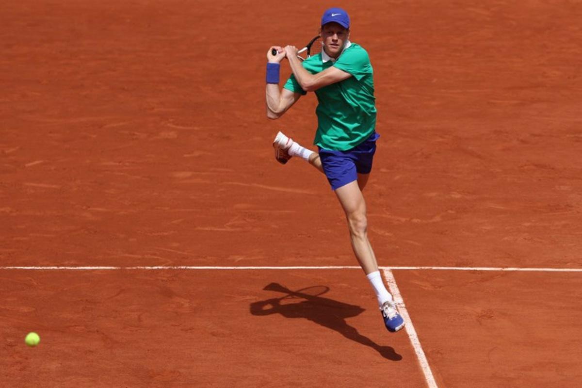 Italy's Jannik Sinner plays a backhand return to France's Richard Gasquet during their men's singles match on day 5 of the French Open tennis tournament on Court Philippe-Chatrier at the Roland-Garros Complex in Paris on May 29, 2025.  ALAIN JOCARD / AFP