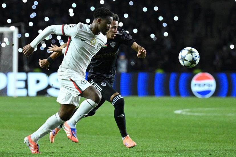 Chelsea's Dutch defender #21 Jorrel Hato and Qarabag's Colombian forward #17 Camilo Duran vie for the ball during the UEFA Champions League league phase football match between Qarabag and Chelsea at the Tofiq Bahramov Republican Stadium in Baku on November 5, 2025.  Tofik BABAYEV / AFP